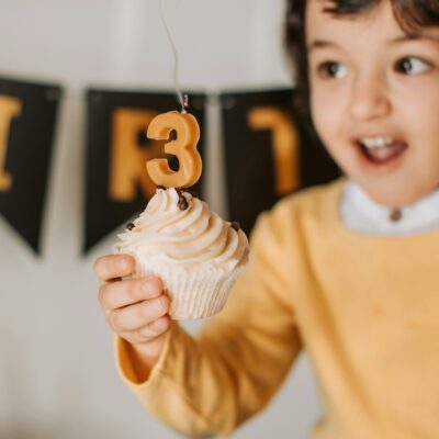 Photograph of a Girl Holding a Cupcake